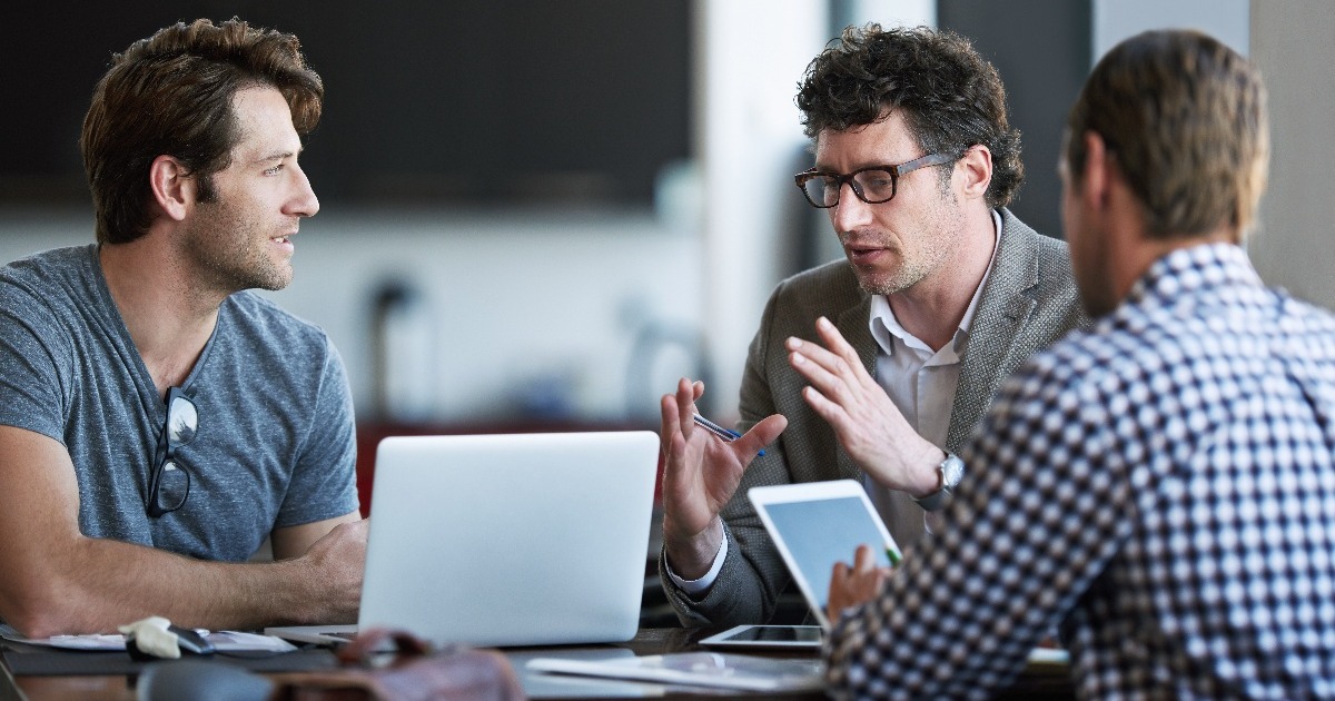 Men talking around a table